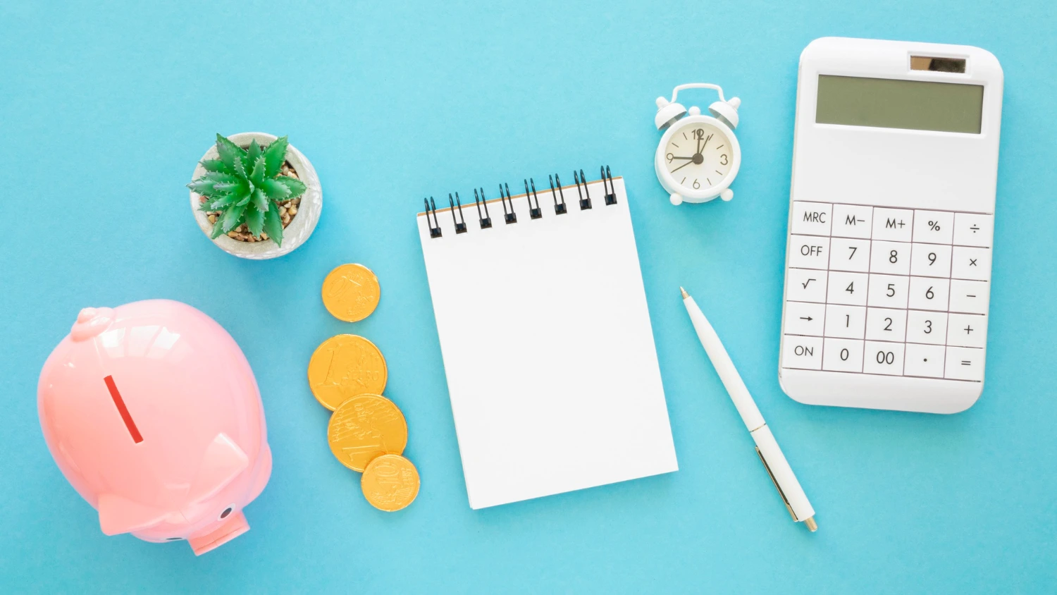 A student using a calculator and notebook to create a budget, surrounded by textbooks, a laptop, and a cup of coffee.