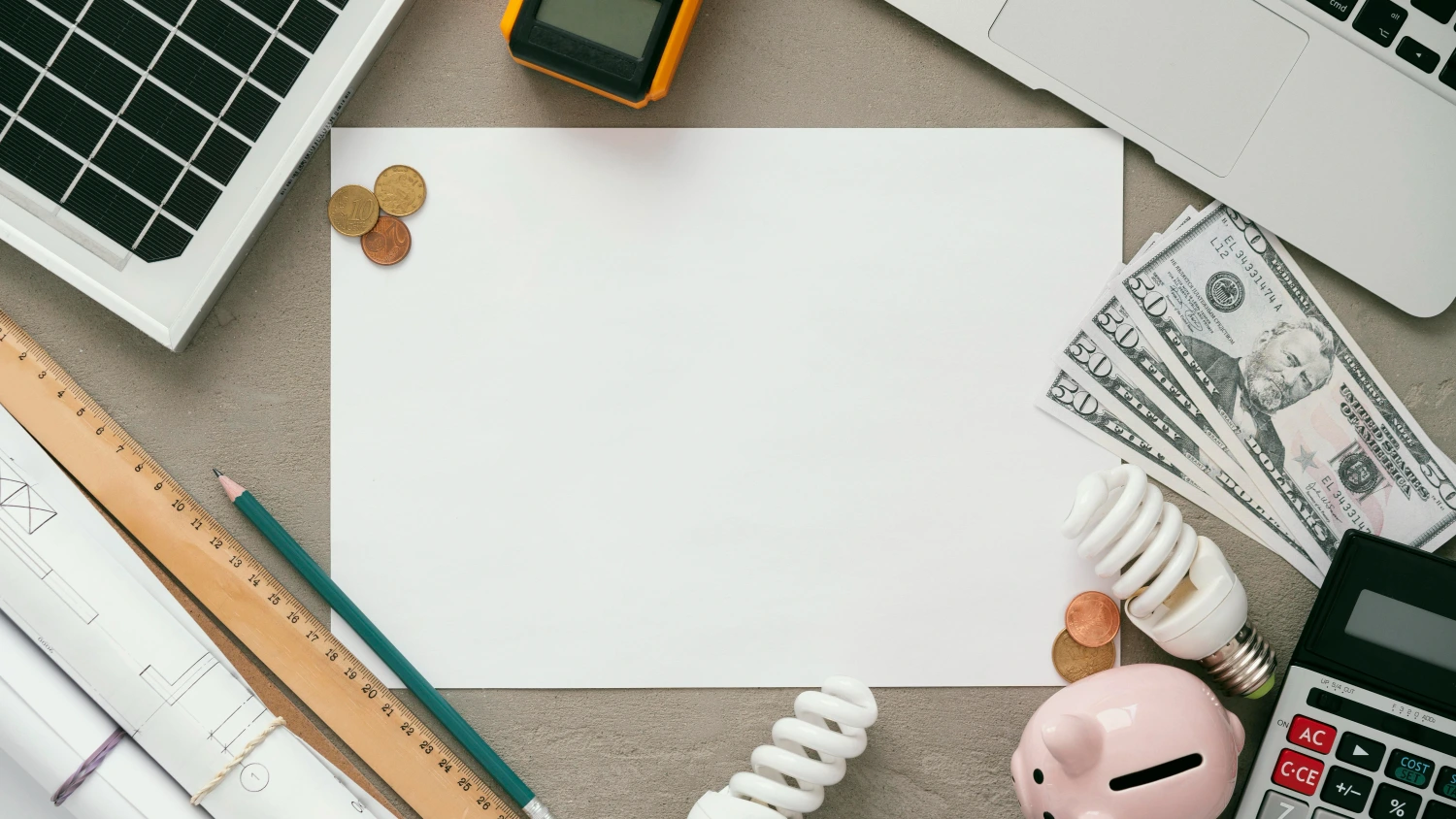 A student writing financial goals in a notebook, with a piggy bank, calculator, and investment books on the table.